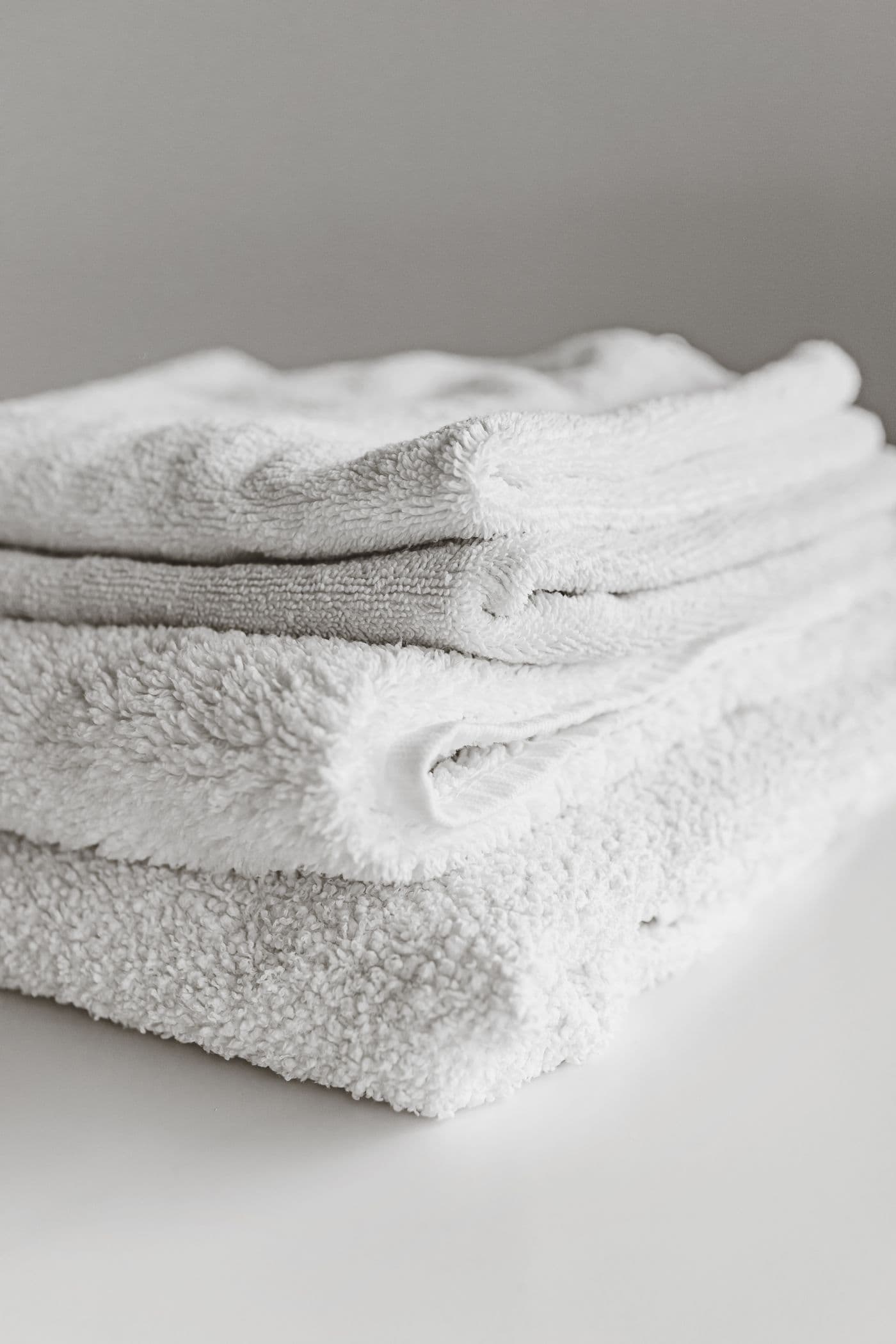 Neatly folded white towels; illustrative stock photograph